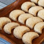 Halfmoon coconut cookies served on a wooden tray