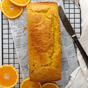 orange cake loaf on a cooling rack