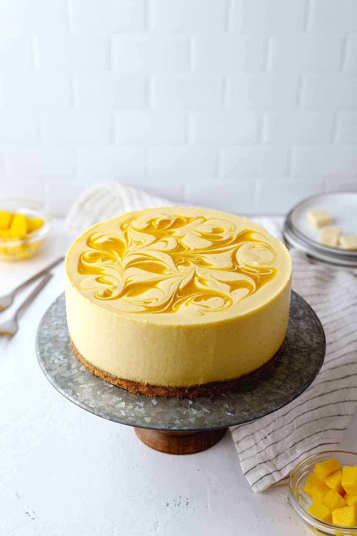 mango cheesecake on a cake stand