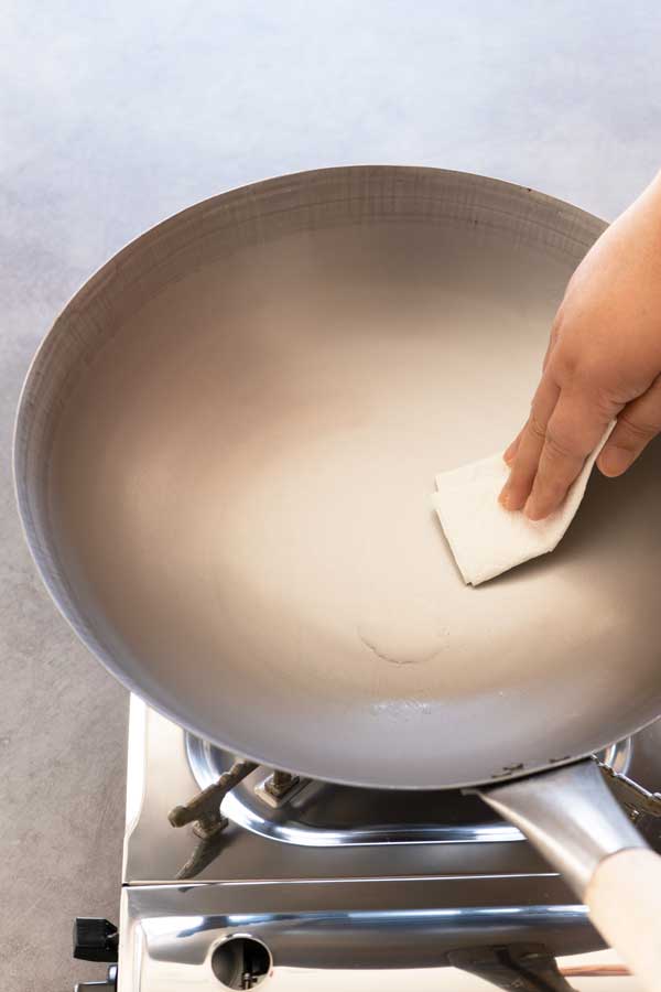 oiling a carbon steel wok to season it