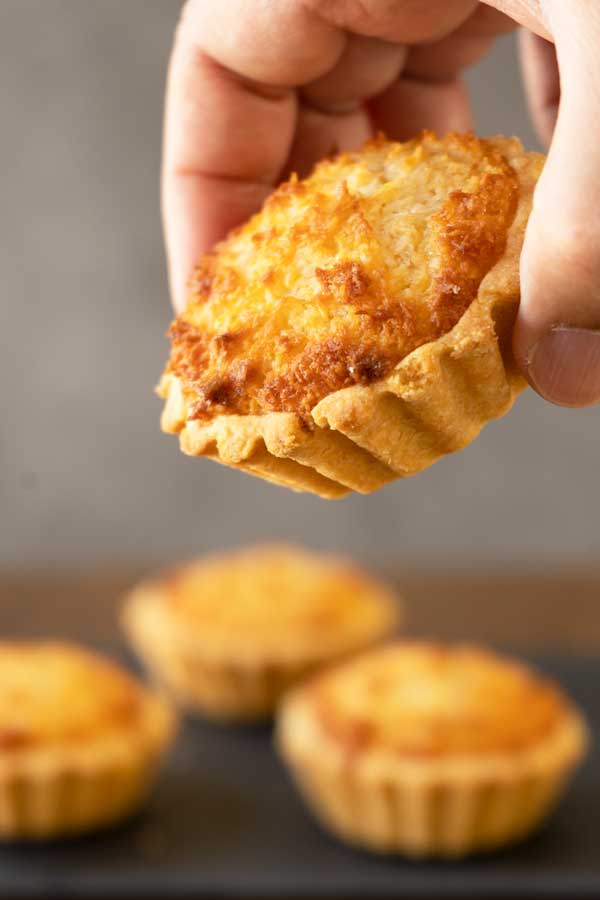 holding a mini coconut tart