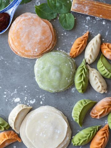 Colourful dumpling wrappers on a table