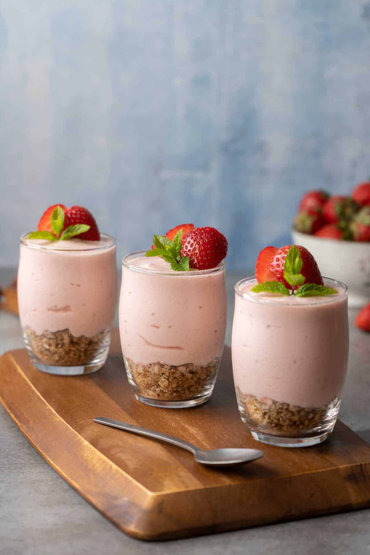 Three Strawberry Cheesecake Shots on a table