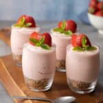 Four Healthier Strawberry Cheesecake Shots on a table