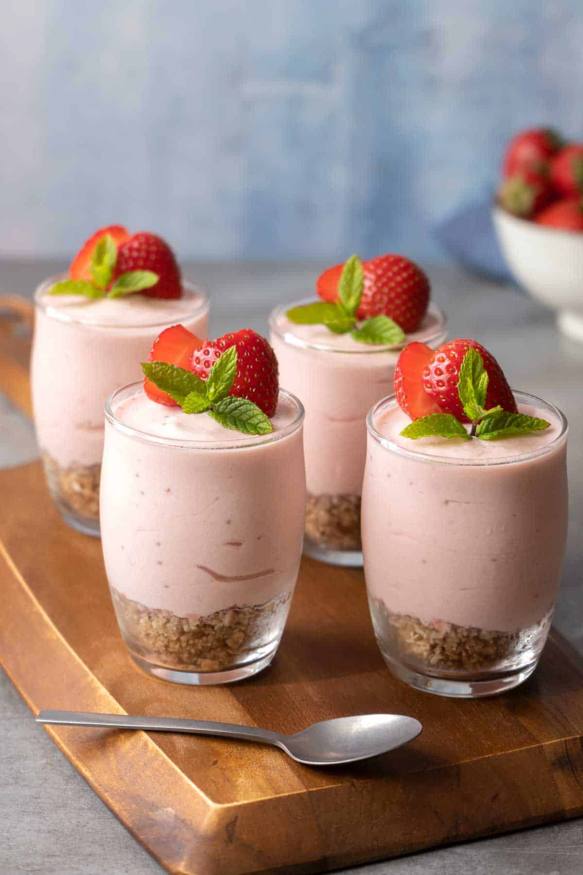 Four Healthier Strawberry Cheesecake Shots on a table