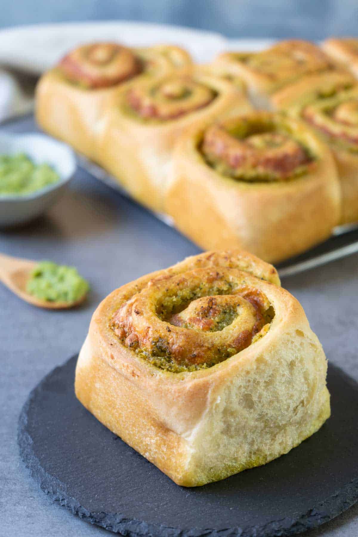 Pesto roll bread on a black stone plate