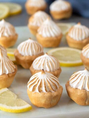 Lemon meringue pie bites on a marble table