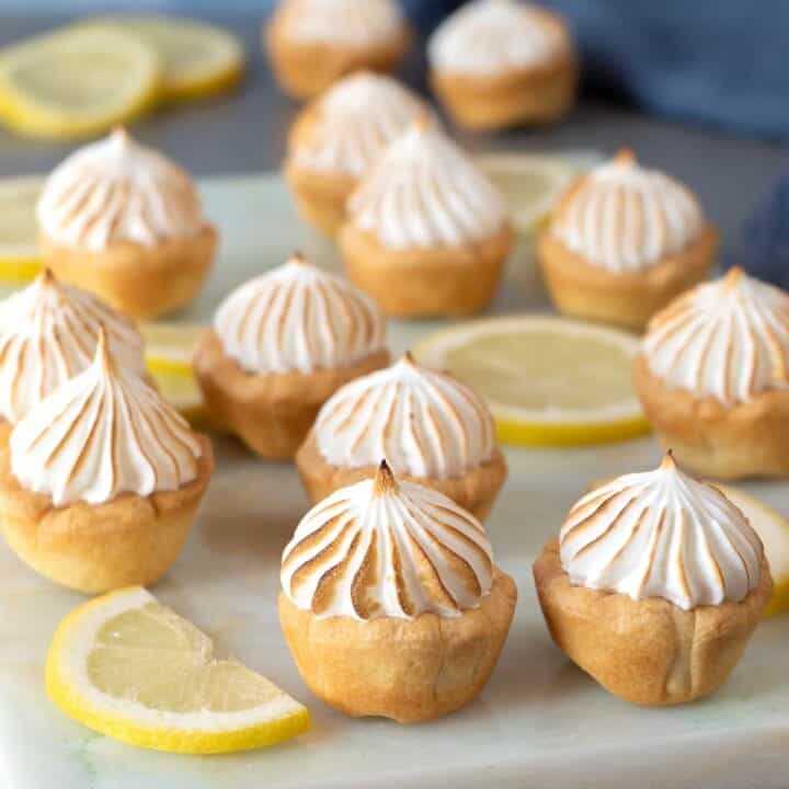 Lemon meringue pie bites on a marble table
