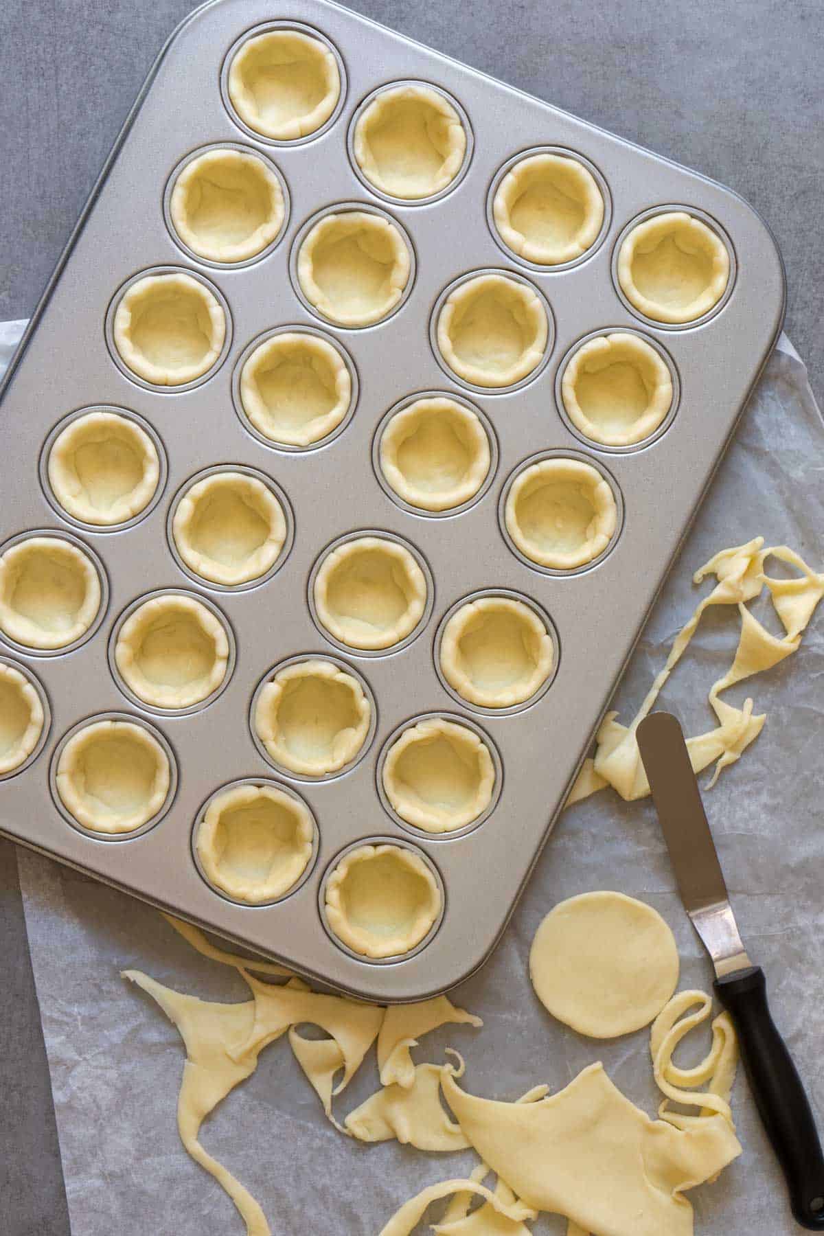 Raw shortcrust pastry in mini muffin pan