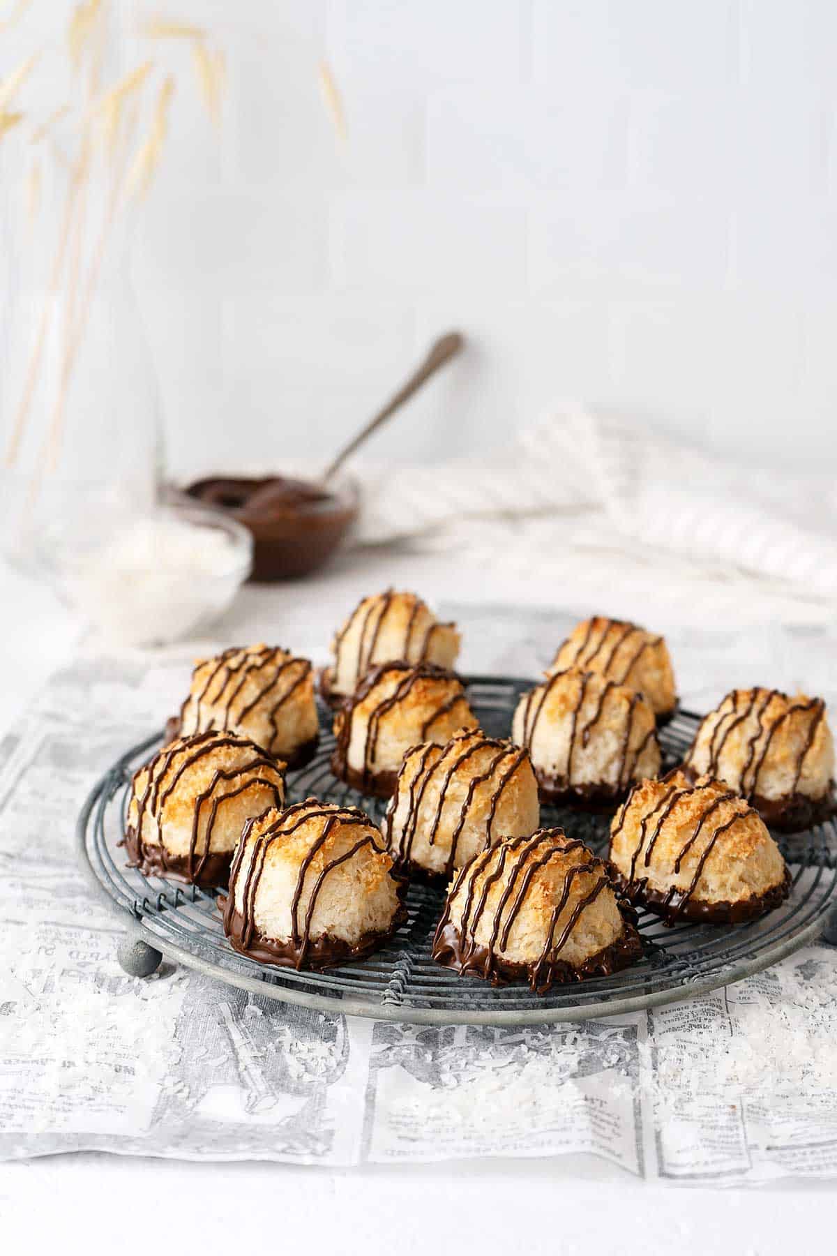 coconut macaroons with chocolate on a cooling rack