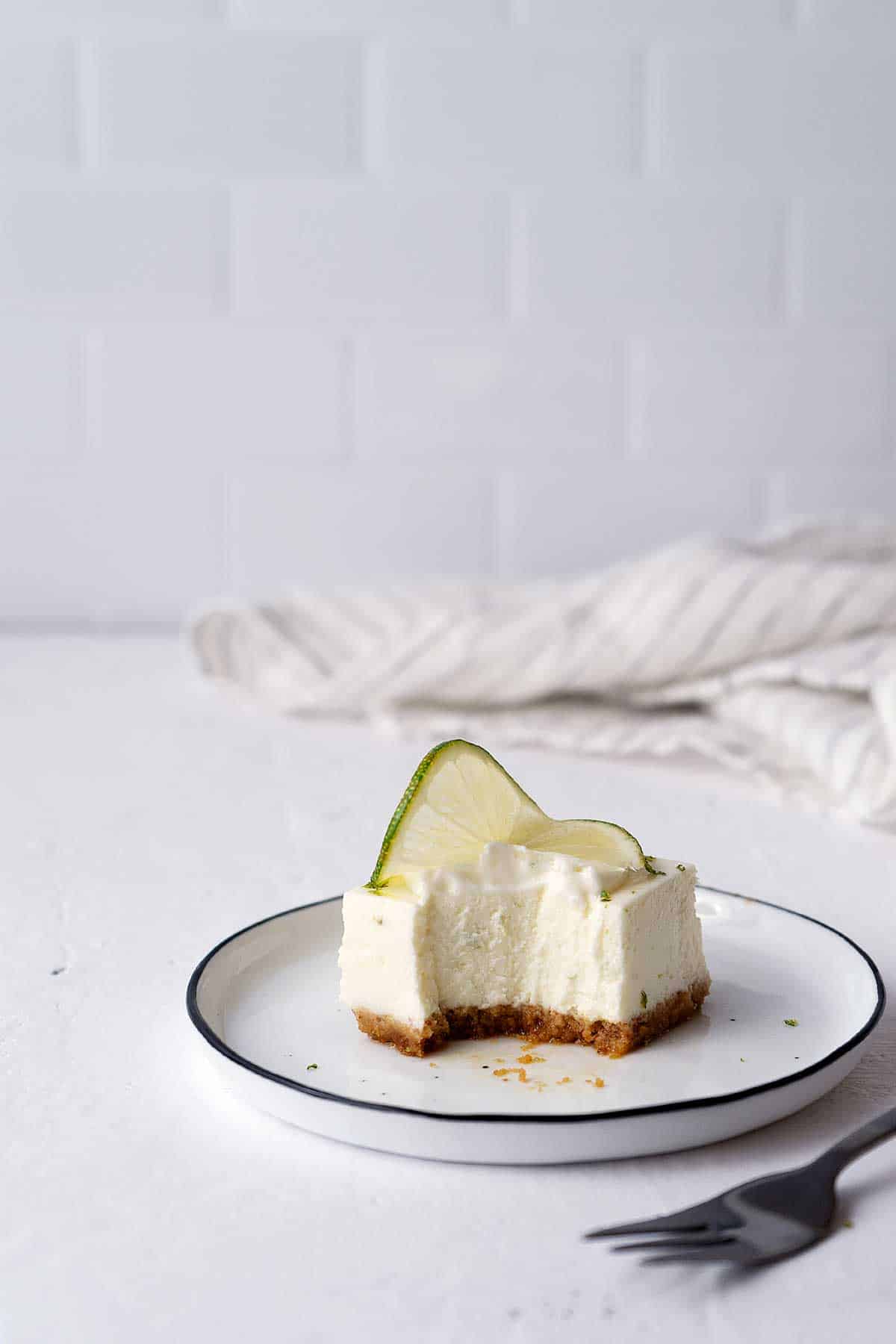 Eaten lime cheesecake bar on a plate