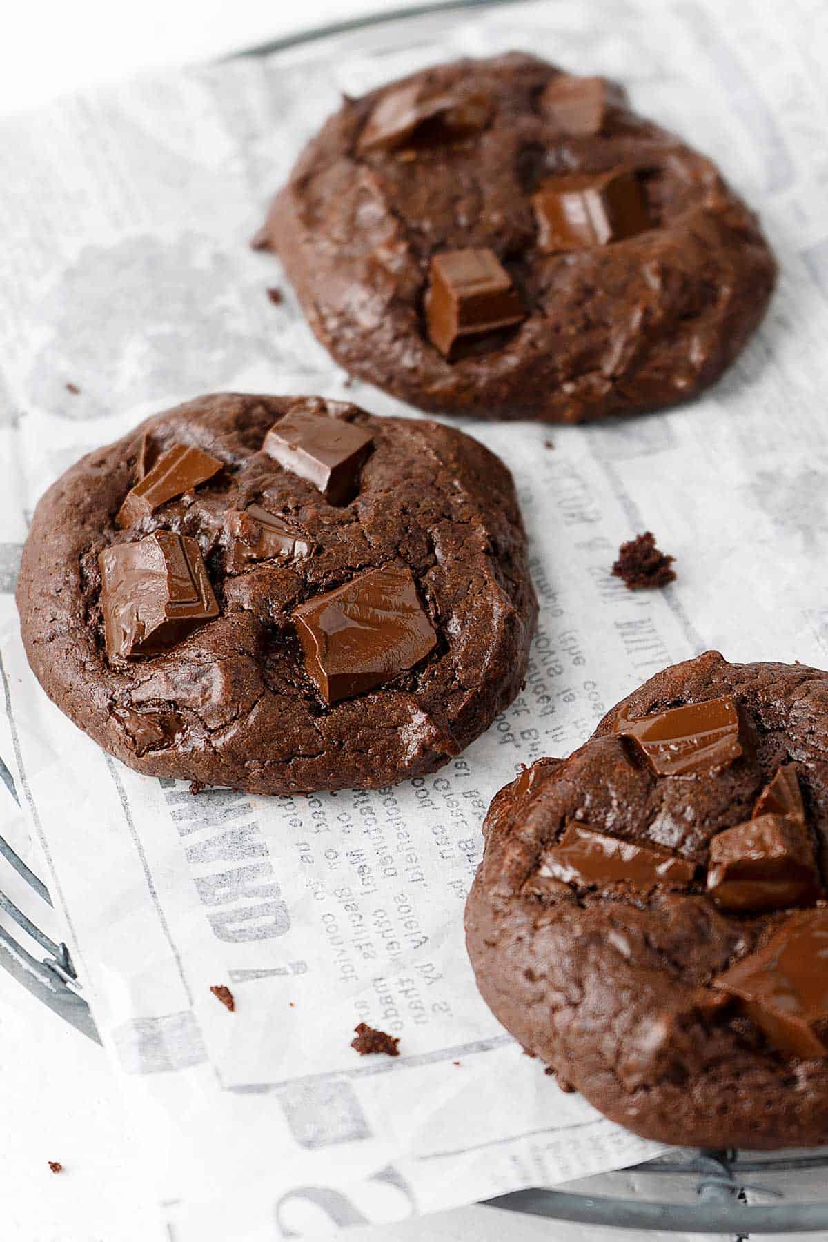 3 chocolate fudge cookies on a paper