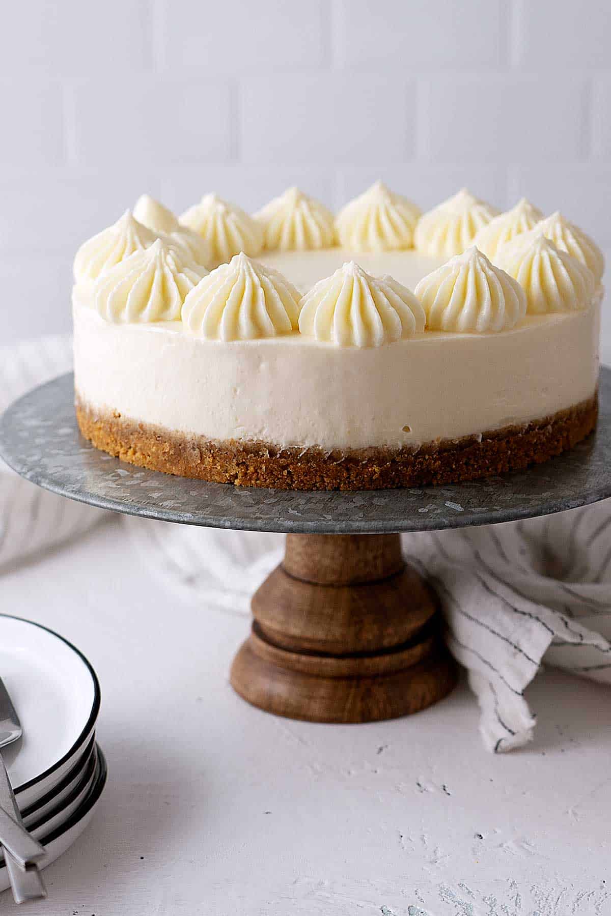 vanilla cheesecake on a cake stand