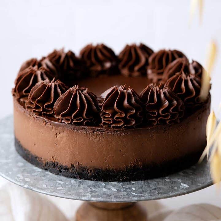 Chocolate cheesecake on a cake stand.