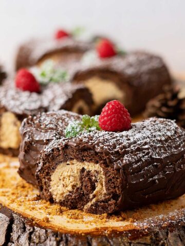 mini yule logs decorated on a wooden table.