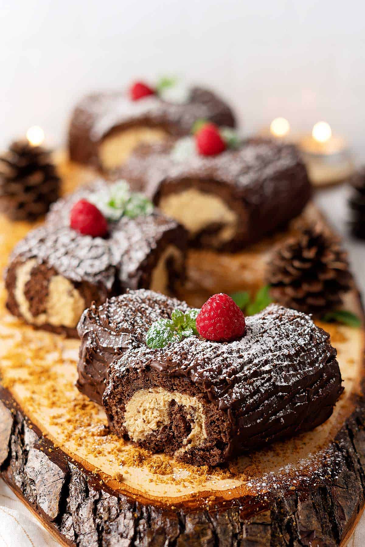 Four Mini Bûche de Noël on a log serving tray.