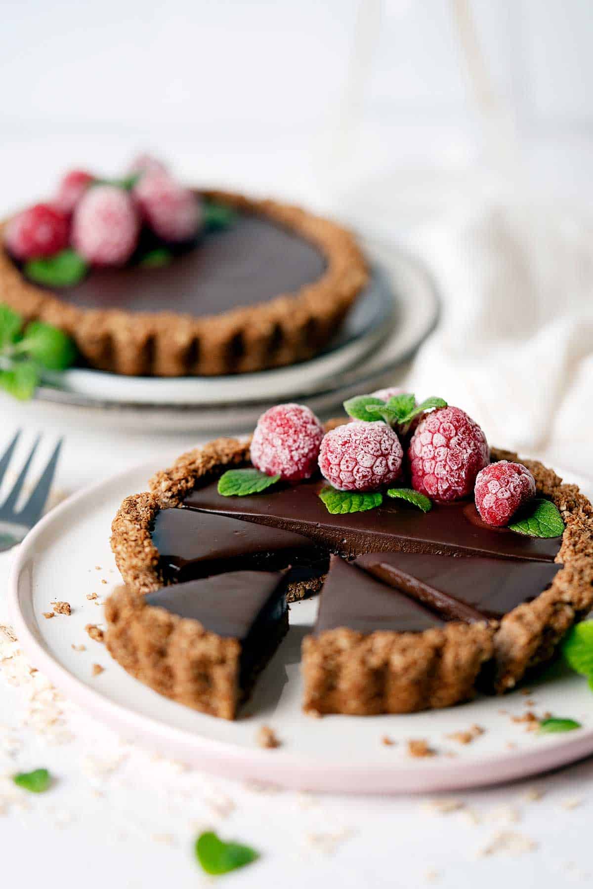 Healthy chocolate coconut tarts with a few slices view from front