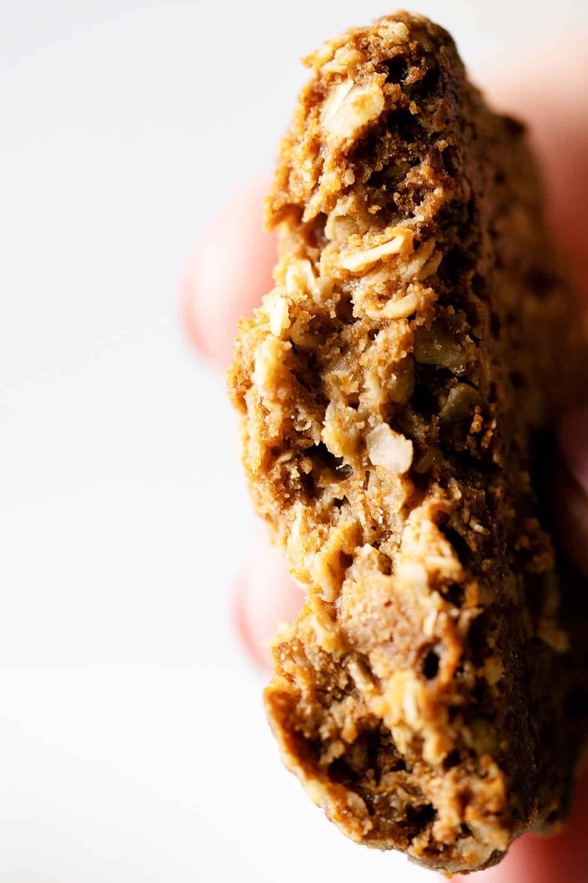 Showing the inside texture of one healthy tahini cookie