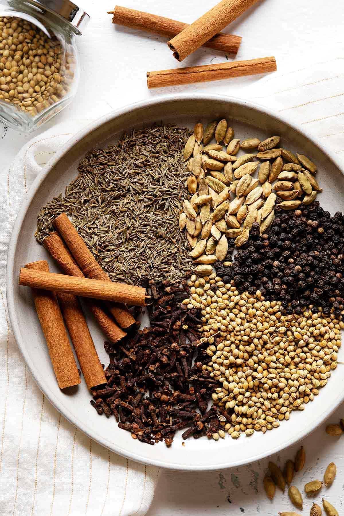 Spices for homemade garam masala in a plate