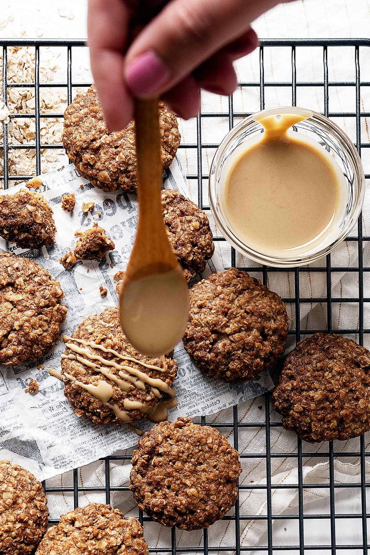 Spooning some tahini on one of the tahini cookies