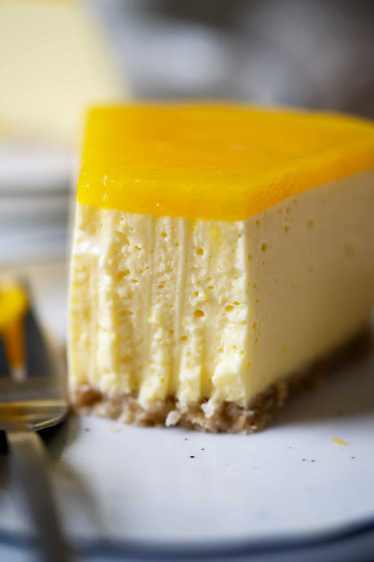 Half eaten of a slice of healthy no bake mango cheesecake