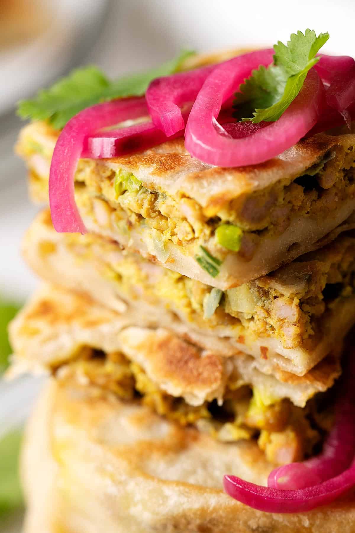 Close up showing the texture of a sliced chicken murtabak flatbread