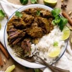 overhead view of half eaten beef rendang with rice.