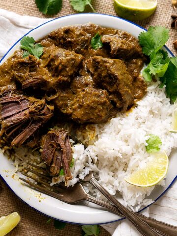 overhead view of half eaten beef rendang with rice.