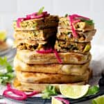 Whole and slices of chicken murtabak flatbreads stacked