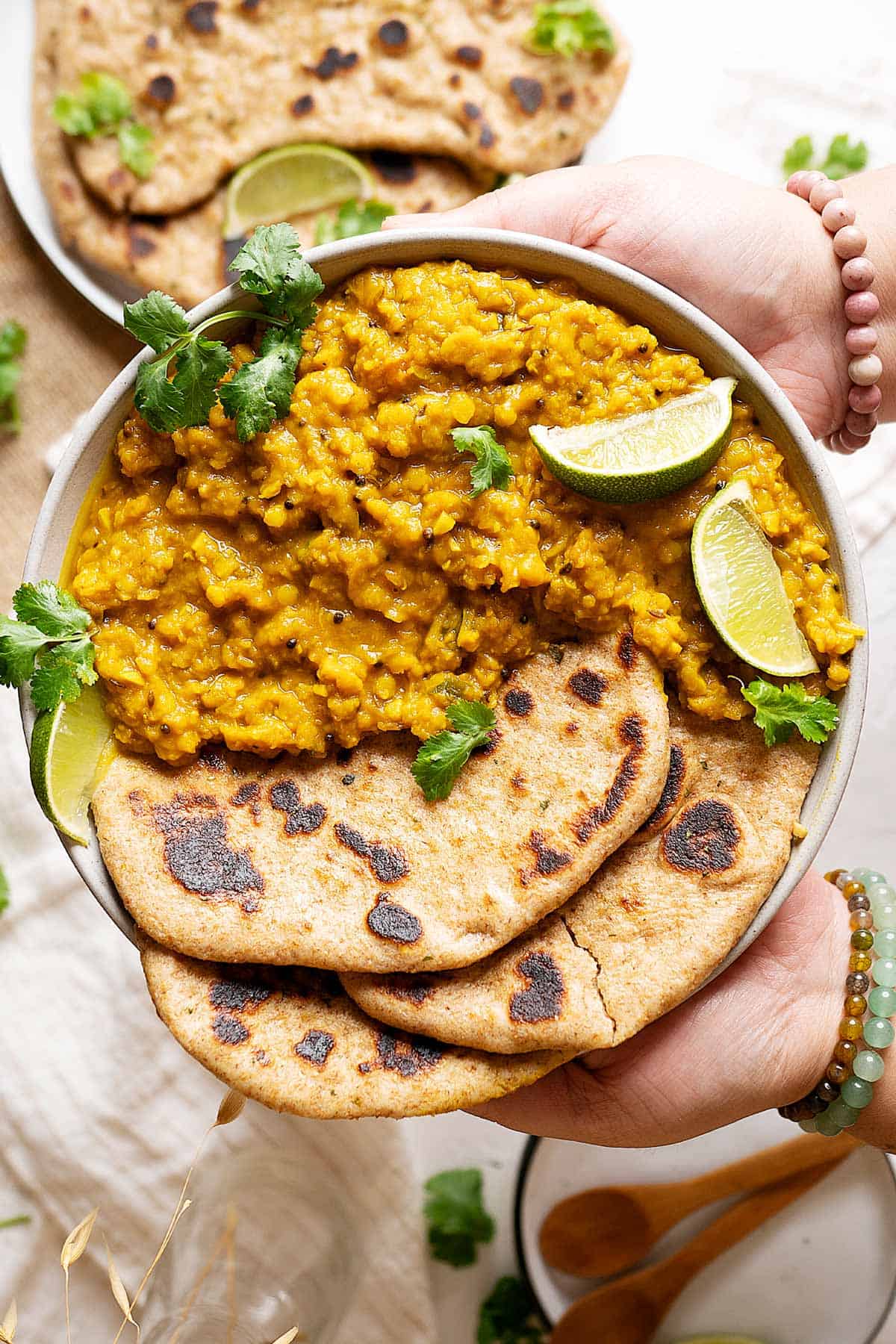 Holding a plate of lentils turmeric curry