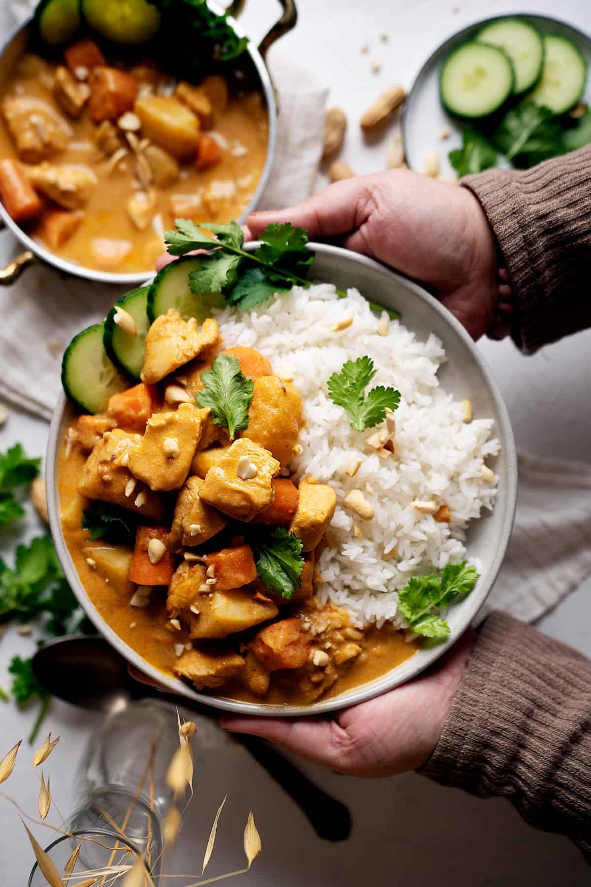 Holding a plate of quick chicken massaman curry