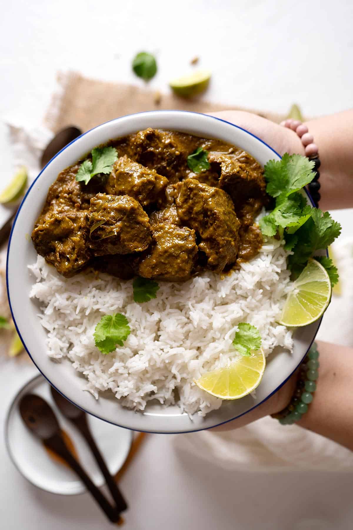 serving a plate of beef rendang curry with white rice.