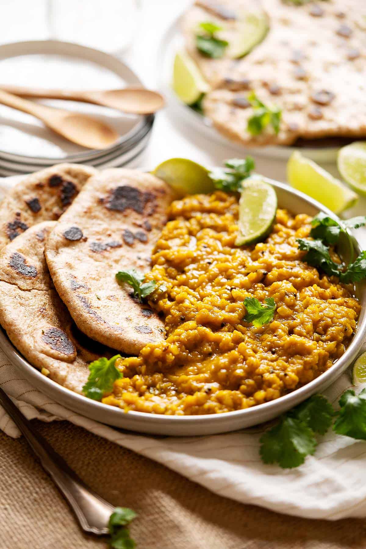 Lentils turmeric curry in a plate with some flatbreads