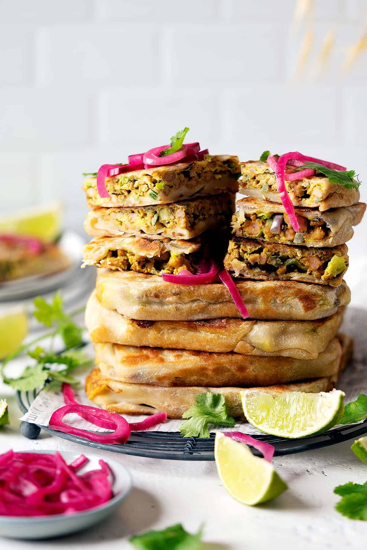 Whole and sliced chicken murtabak flatbreads stacked