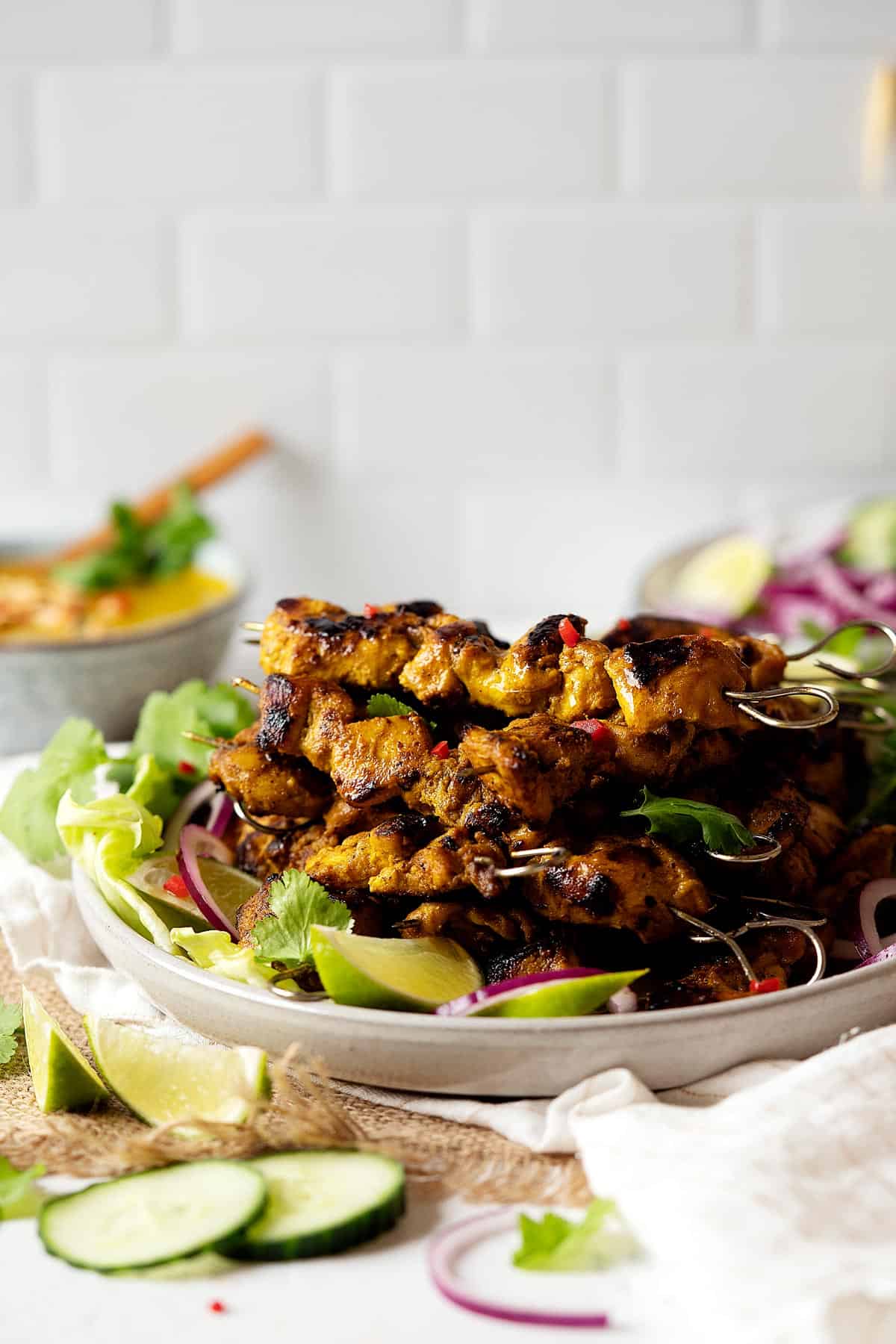 Easy chicken satay stacked on a plate view from front