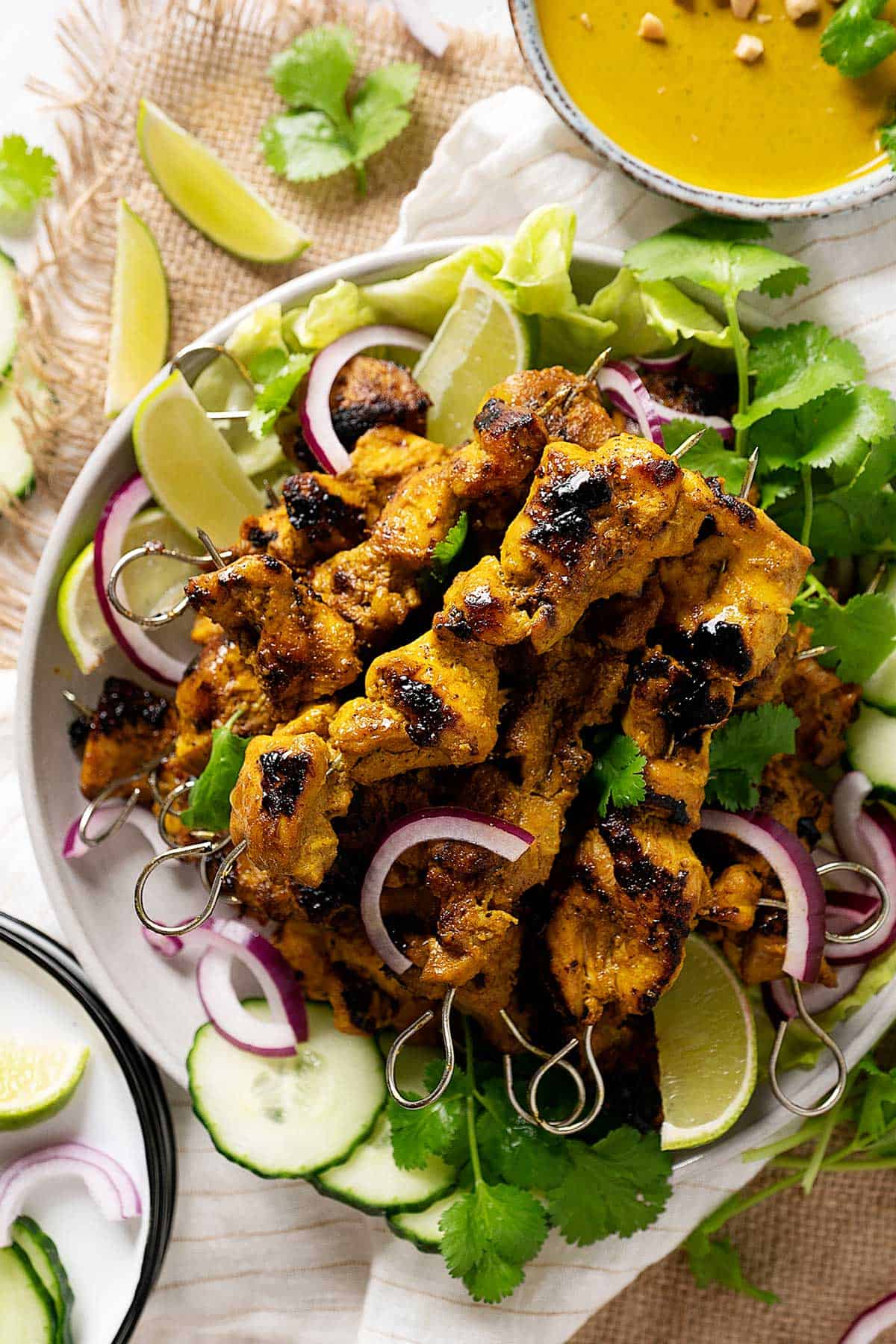 Easy chicken satay stacked on a plate view from top