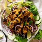 Easy chicken satay stacked on a plate view from top