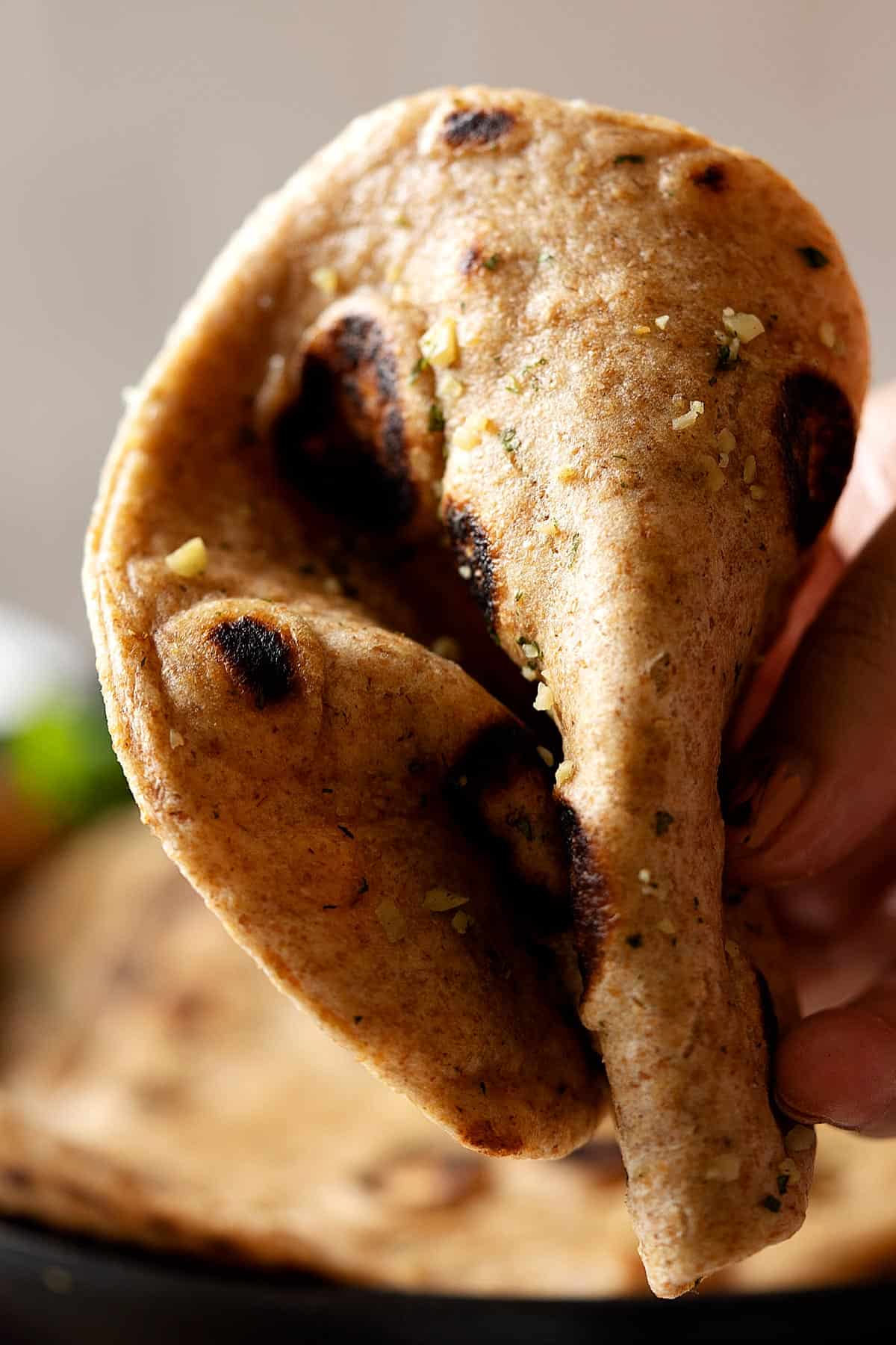 Folding a whole wheat garlic naan