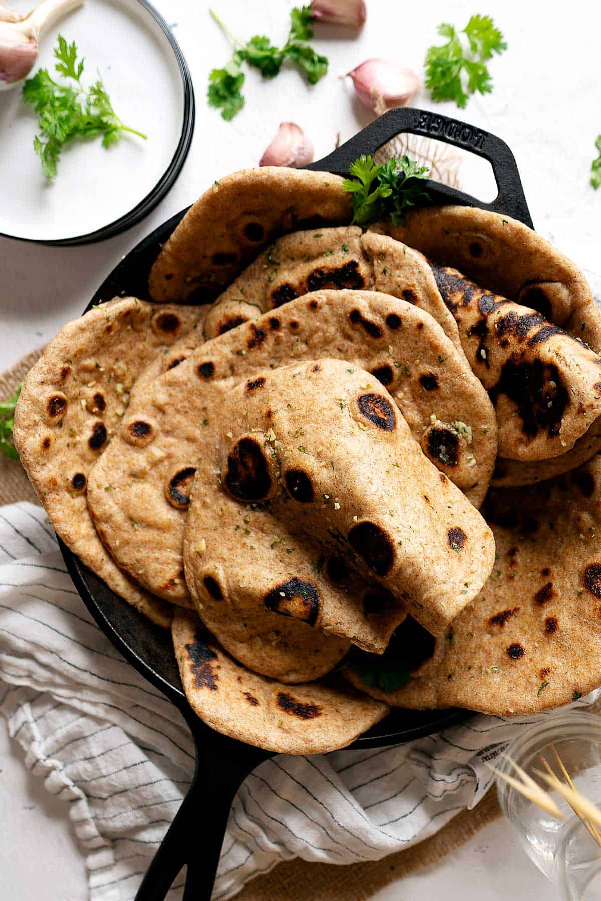 Whole wheat garlic naan in a skillet view from top