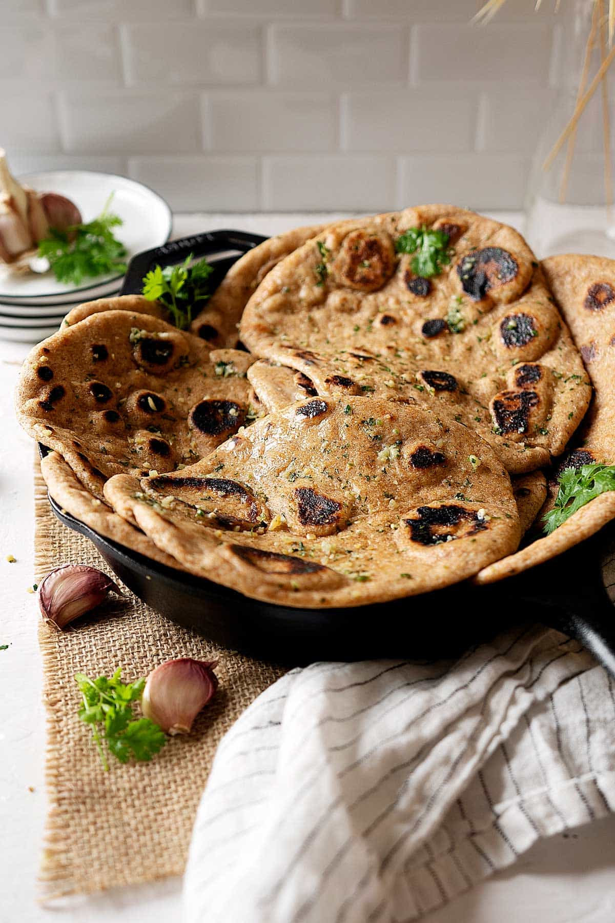 Whole wheat garlic naan in a skillet view from front