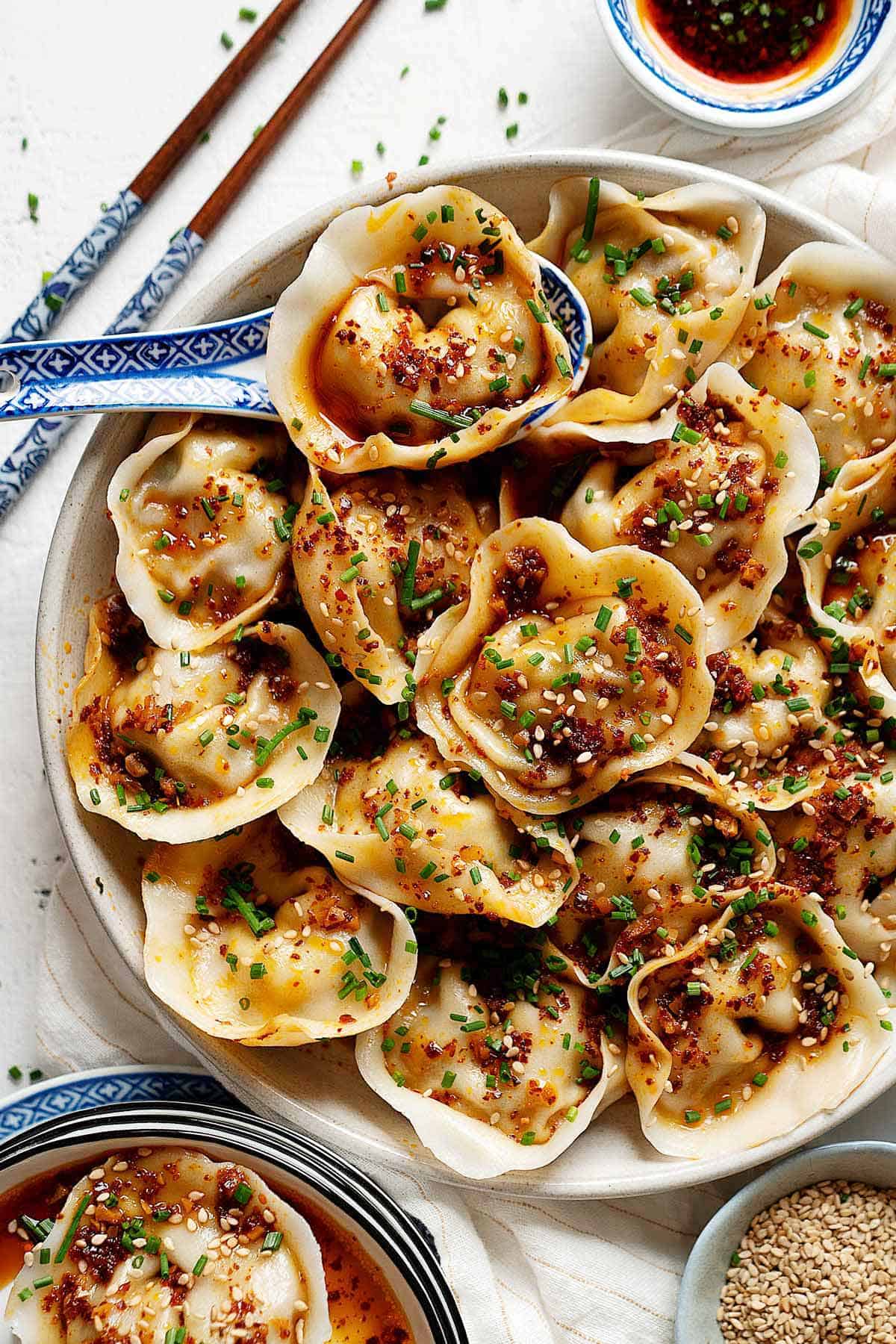 Wontons in garlic chili oil in a plate view from top