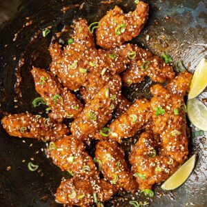 Crispy sesame chicken in a wok