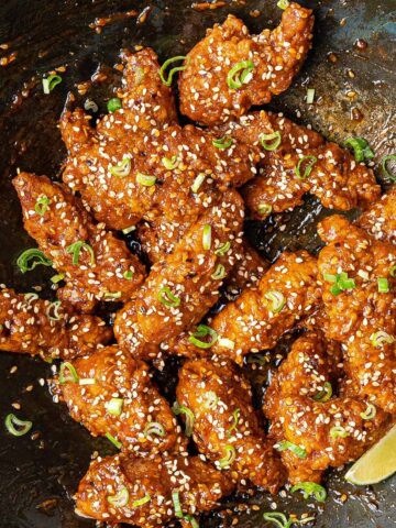 Crispy sesame chicken in a wok