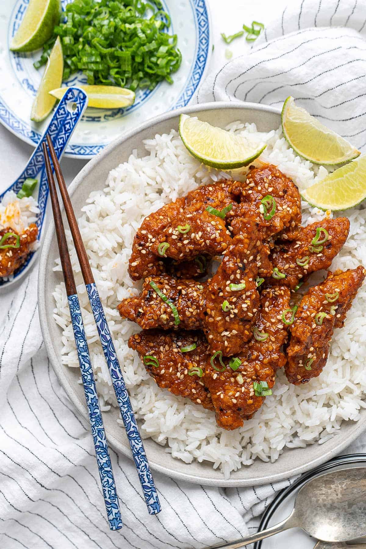 Sesame chicken with some rice in a plate