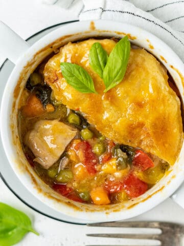 Half eaten basil chicken pot pie in a bowl