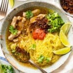 A bowl of lemongrass ginger chicken soup with turmeric rice noodles