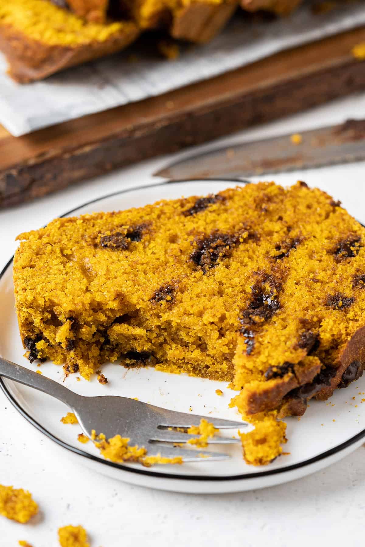 Half eaten healthy chocolate chip pumpkin bread in a plate