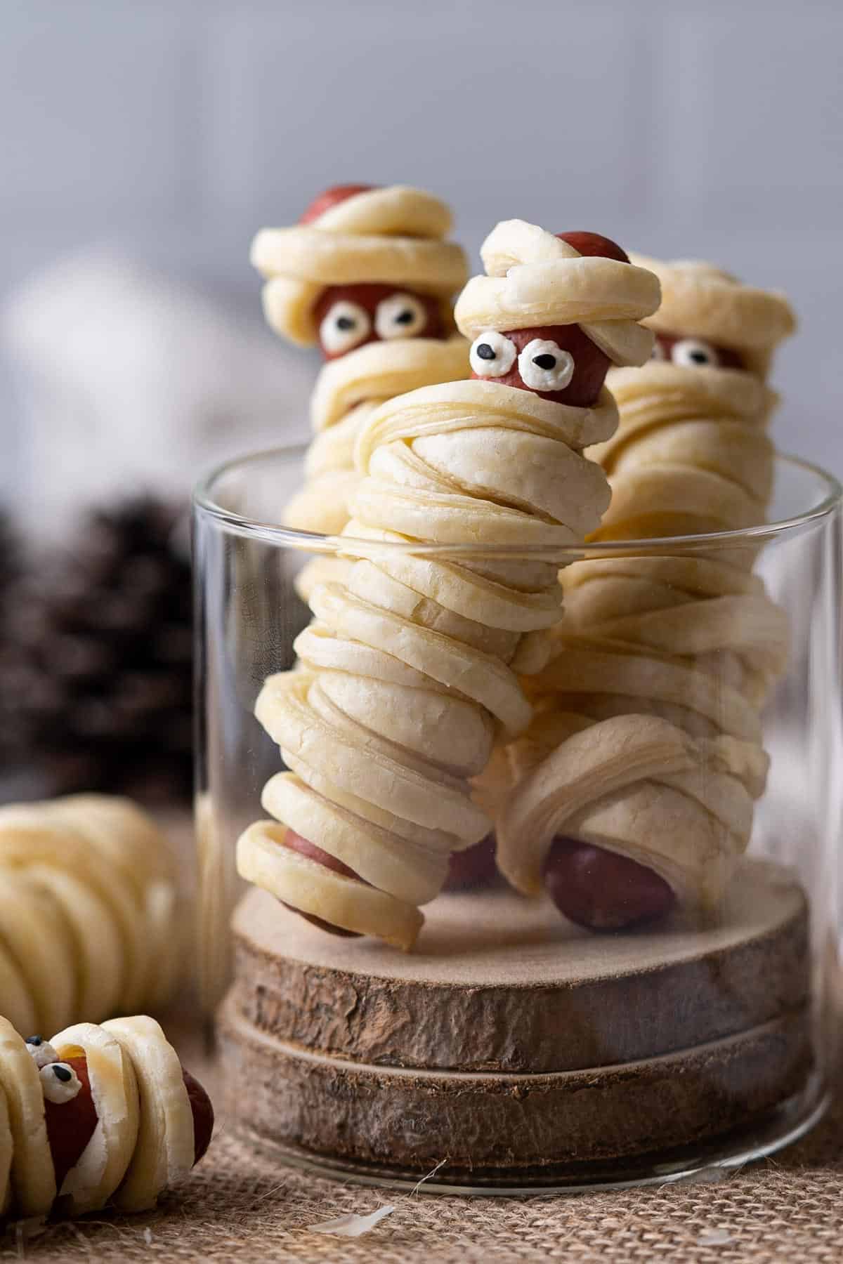 Hot dog mummies in a glass