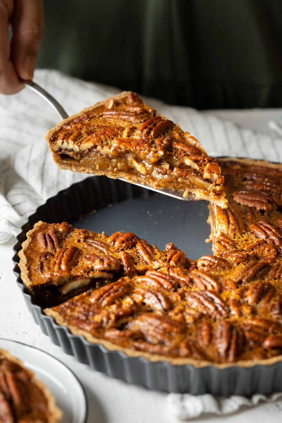 Serving a slice of healthy pecan pie without corn syrup