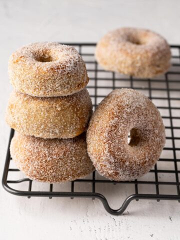 donuts stacked on a cooling rack